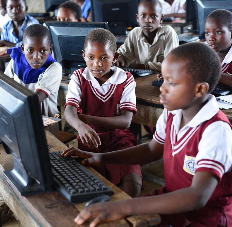 School children learning with a computer.